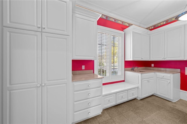 kitchen featuring white cabinets and ornamental molding