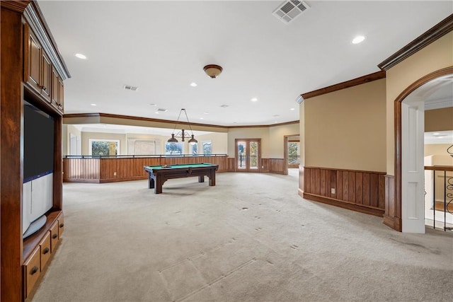 game room with billiards, crown molding, and light carpet