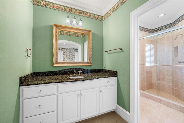 bathroom with vanity, walk in shower, and crown molding