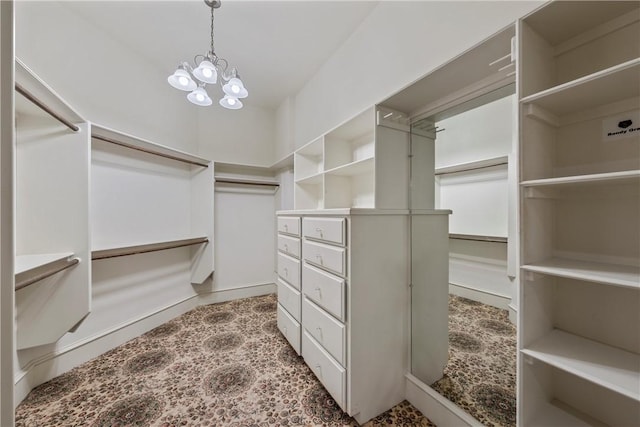 spacious closet with a chandelier