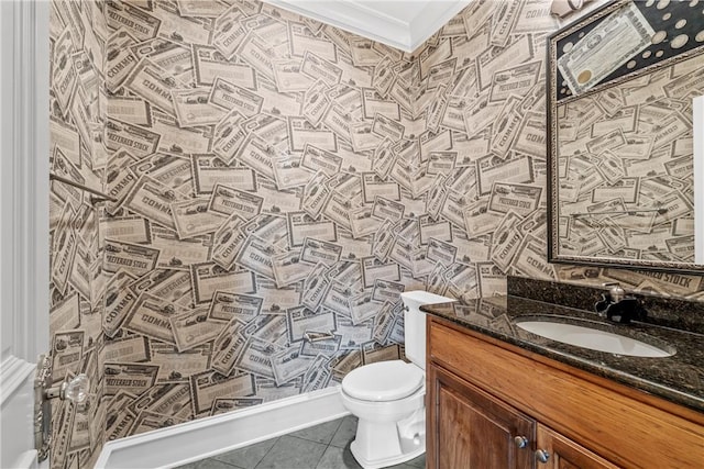 bathroom with toilet, tile patterned flooring, crown molding, and vanity