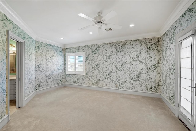 carpeted spare room featuring ceiling fan and crown molding