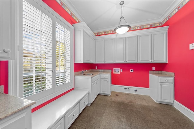 laundry area featuring crown molding, plenty of natural light, cabinets, and hookup for a washing machine