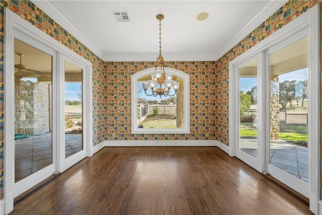 unfurnished dining area featuring french doors, a chandelier, plenty of natural light, and dark hardwood / wood-style floors