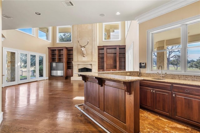 kitchen featuring sink, a breakfast bar, a healthy amount of sunlight, and french doors