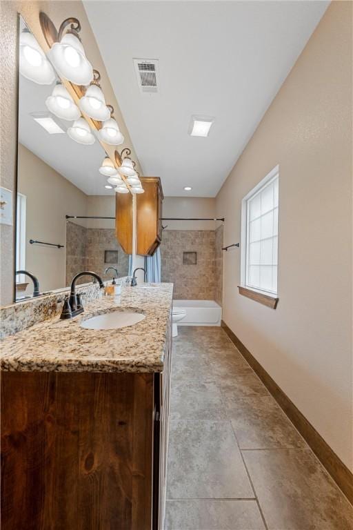 bathroom with vanity, baseboards, visible vents, shower / bathing tub combination, and toilet