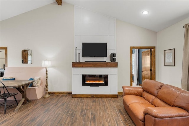 living room with lofted ceiling, a glass covered fireplace, dark wood-style floors, recessed lighting, and baseboards