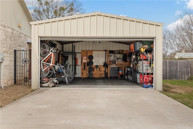 detached garage featuring fence