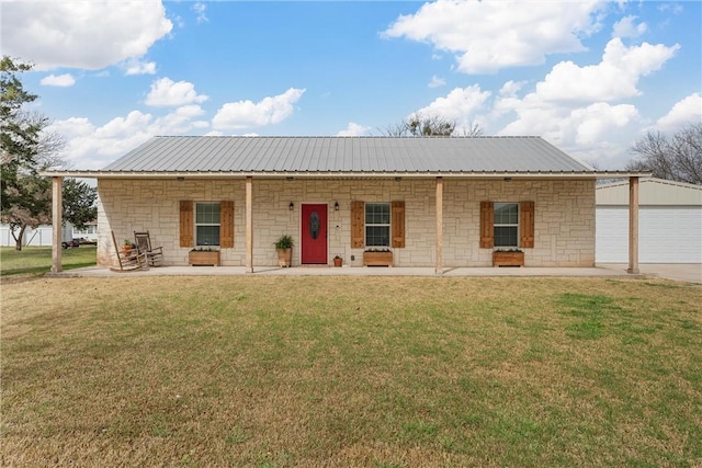 ranch-style house featuring metal roof, stone siding, and a front yard