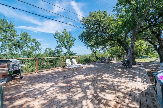 wooden deck with a grill