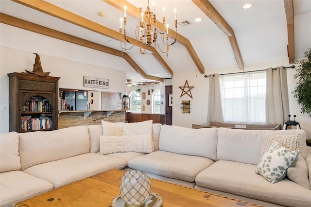 living room featuring vaulted ceiling with beams and ceiling fan with notable chandelier