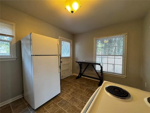 kitchen with a healthy amount of sunlight and white appliances