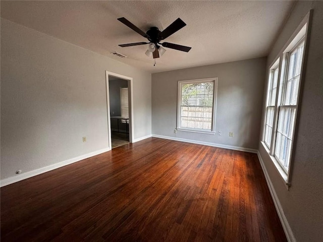 empty room featuring dark hardwood / wood-style floors and ceiling fan