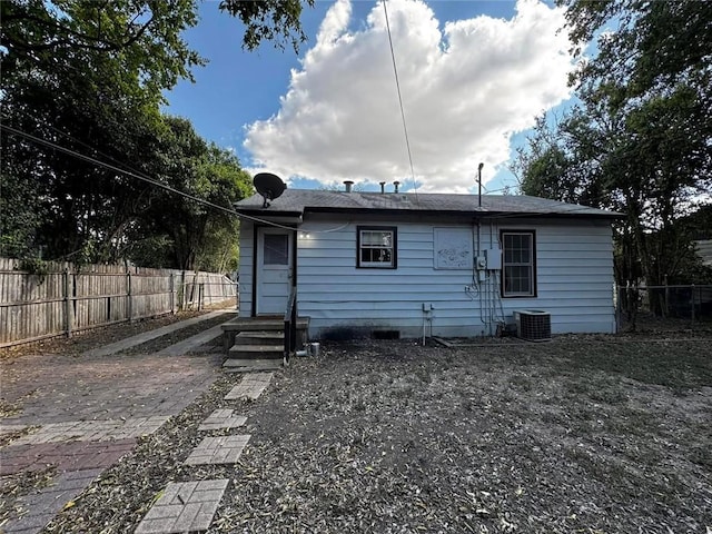 rear view of house with central AC unit