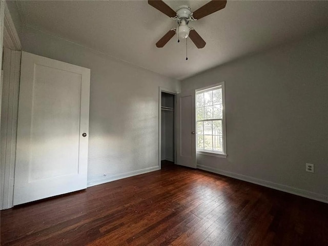 unfurnished bedroom with dark hardwood / wood-style floors and ceiling fan