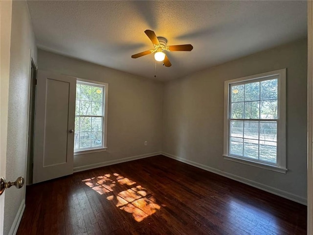 spare room featuring a textured ceiling, dark hardwood / wood-style flooring, and ceiling fan