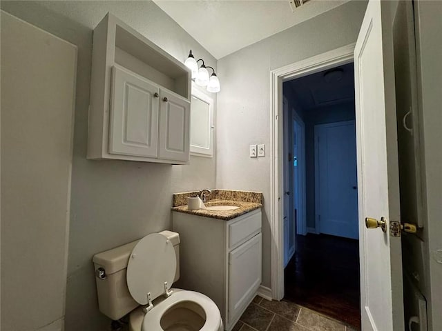 bathroom with tile patterned flooring, vanity, and toilet