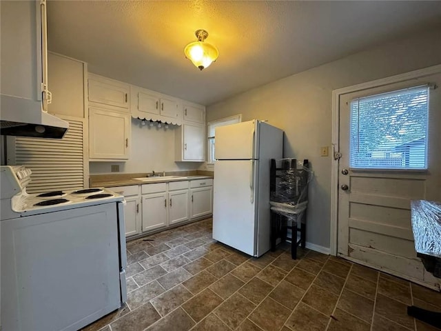 kitchen with white cabinets, white appliances, and sink