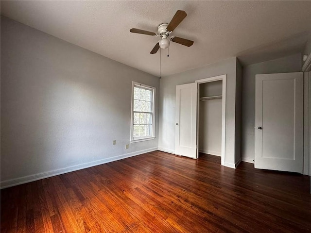 unfurnished bedroom with dark hardwood / wood-style flooring and ceiling fan