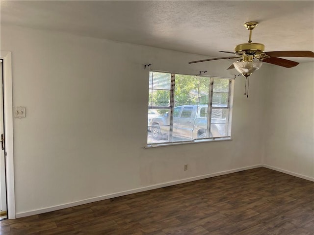 unfurnished room featuring ceiling fan and dark wood-type flooring