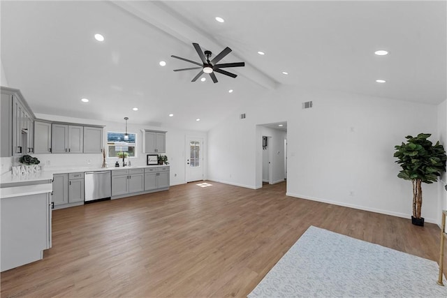 living room with light wood-type flooring, lofted ceiling with beams, ceiling fan, and sink