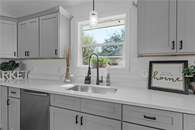 kitchen featuring dishwasher, sink, gray cabinets, light stone countertops, and decorative light fixtures