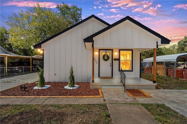 modern farmhouse style home featuring a carport and covered porch