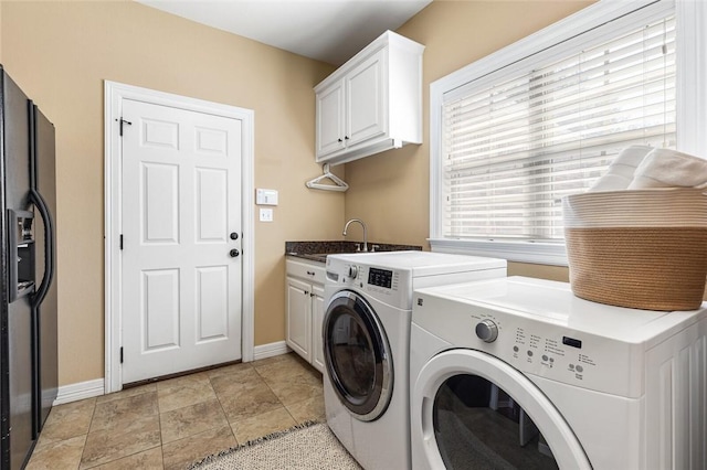 washroom featuring cabinets, light tile patterned floors, sink, and washing machine and clothes dryer