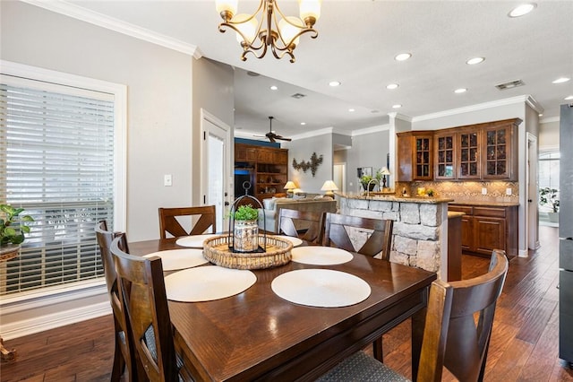 dining room featuring ornamental molding, dark hardwood / wood-style floors, and a healthy amount of sunlight