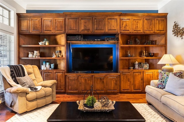 living room with light wood-type flooring and ornamental molding