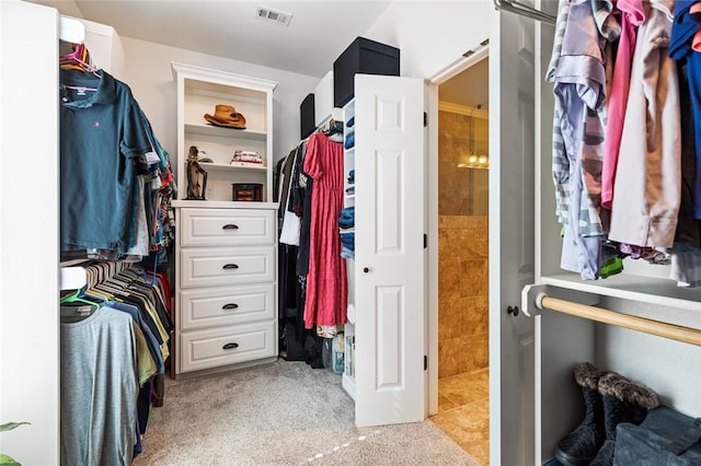 walk in closet with light tile patterned flooring