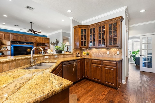 kitchen featuring dishwasher, sink, ornamental molding, dark hardwood / wood-style flooring, and kitchen peninsula