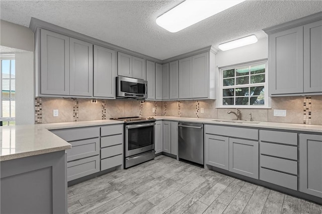 kitchen featuring appliances with stainless steel finishes and gray cabinets