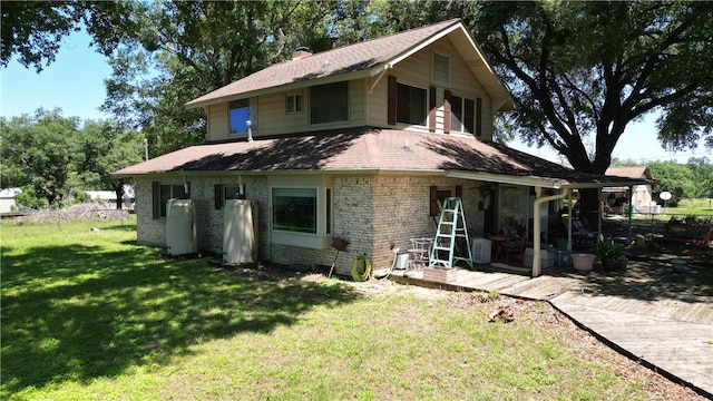 back of property featuring a patio area and a lawn