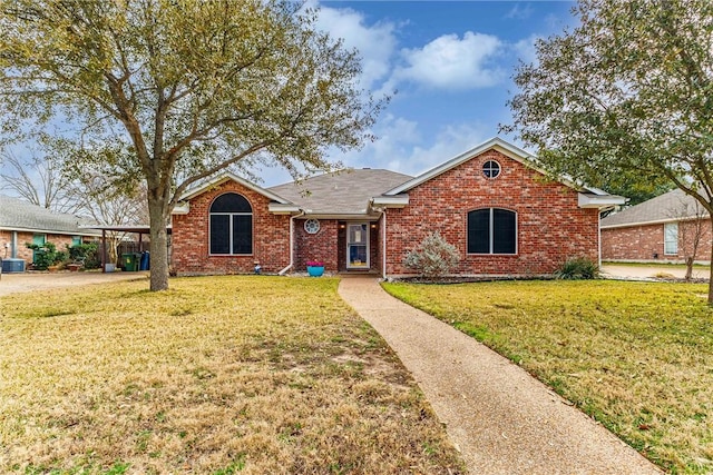 single story home with brick siding, central AC unit, and a front yard