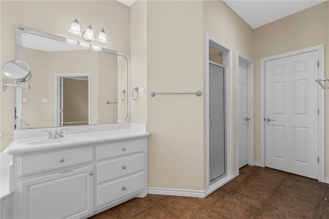 bathroom featuring tile patterned flooring, vanity, and an enclosed shower