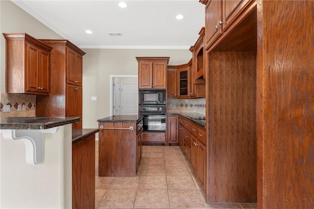 kitchen with tasteful backsplash, black appliances, light tile patterned floors, dark stone countertops, and a center island