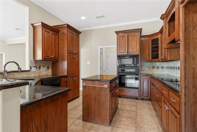 kitchen with a center island, sink, dark stone countertops, decorative backsplash, and black appliances