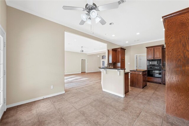 kitchen with a breakfast bar, ceiling fan, crown molding, black appliances, and a kitchen island