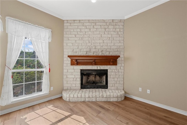 unfurnished living room featuring light hardwood / wood-style flooring, ornamental molding, and a brick fireplace