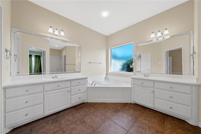 bathroom featuring a bathtub, vanity, and tile patterned flooring