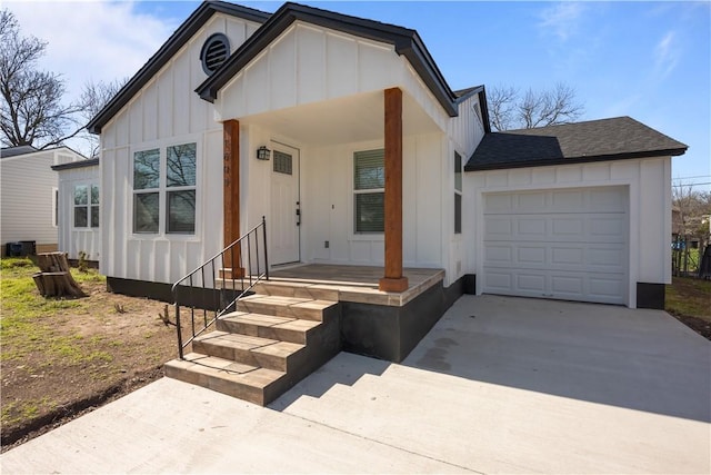 modern farmhouse style home featuring board and batten siding, an attached garage, driveway, and roof with shingles