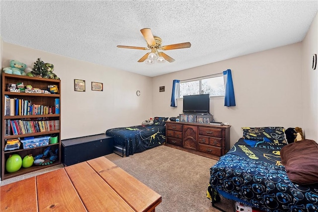 carpeted bedroom featuring a textured ceiling and ceiling fan