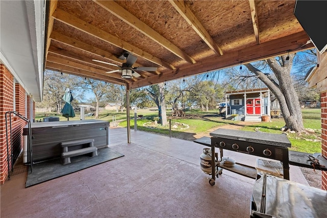 view of patio / terrace with ceiling fan and a hot tub