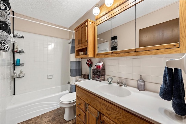 full bathroom featuring backsplash, vanity, a textured ceiling, tiled shower / bath combo, and toilet