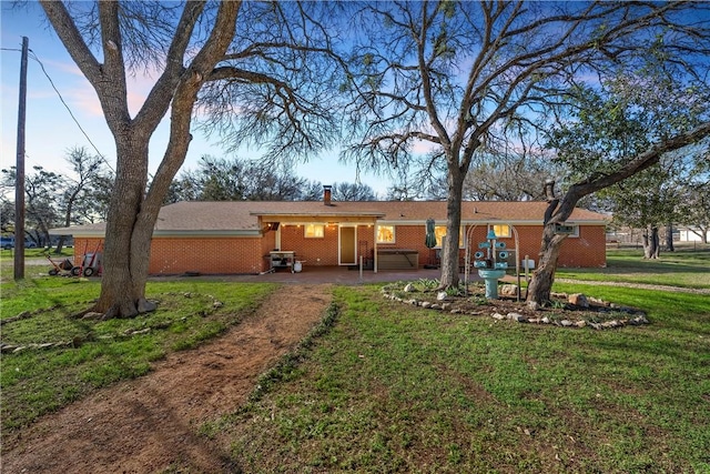 back of house featuring a patio and a lawn