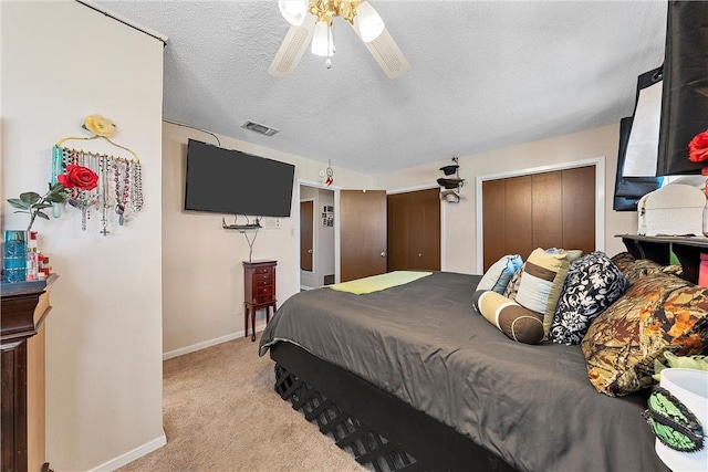 bedroom with light carpet, a textured ceiling, a closet, and ceiling fan