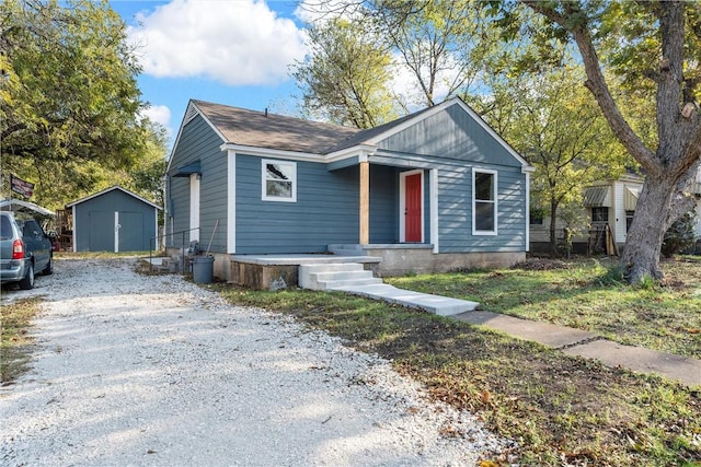 bungalow-style home with a shed