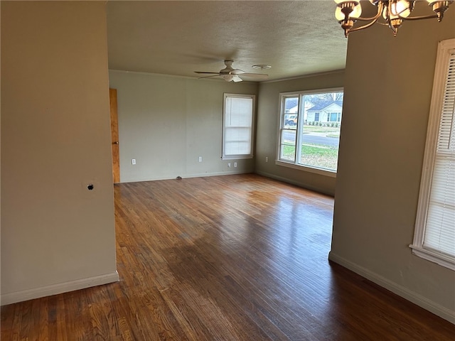 spare room featuring baseboards, a textured ceiling, wood finished floors, and ceiling fan with notable chandelier