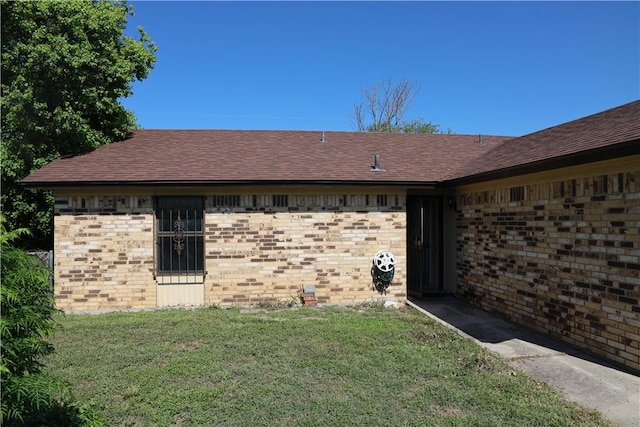 view of side of home featuring a yard